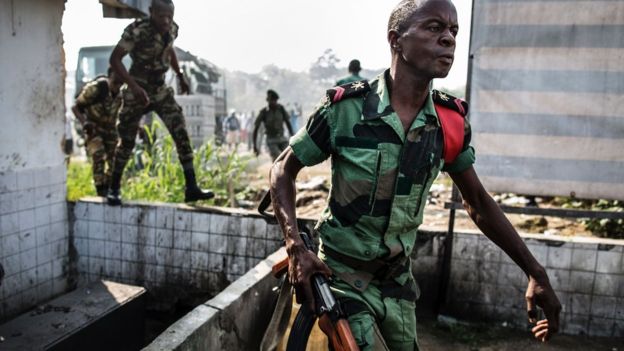 Un soldado gabonés corre para tomar la posición como partidarios de la protesta de Jean Ping del líder de oposición